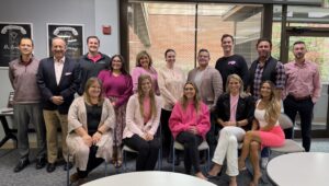 The Financial Guys show their support by dressing in pink during Breast Cancer Awareness Month.